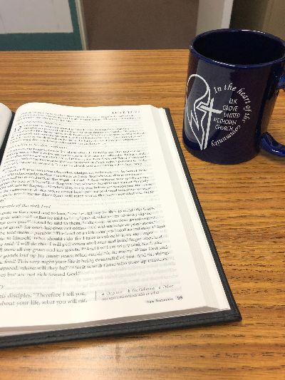 Open Bible and mug with heart on it